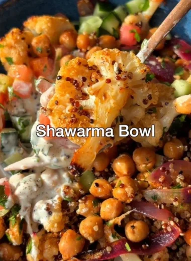 Delicious Cauliflower Shawarma Bowl on a sheet pan with fresh vegetables.