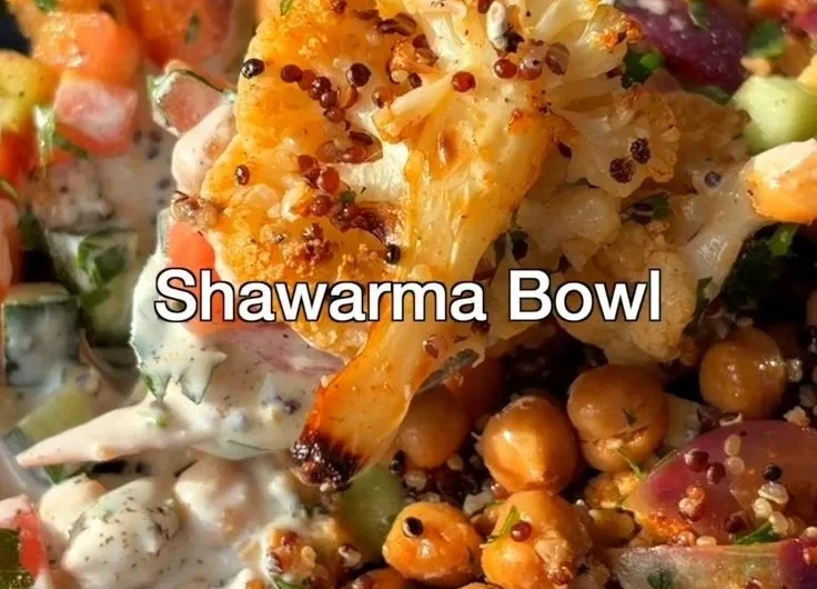 Delicious Cauliflower Shawarma Bowl on a sheet pan with fresh vegetables.