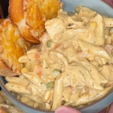 Crock Pot Chicken Pot Pie Pasta served in a bowl with herbs on top.