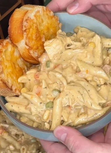 Crock Pot Chicken Pot Pie Pasta served in a bowl with herbs on top.
