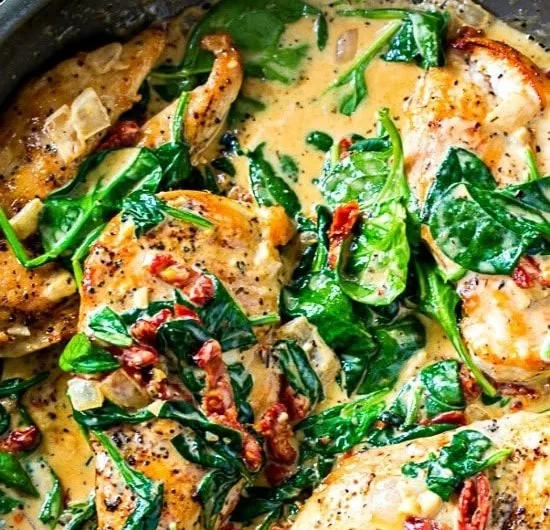 Delicious low carb creamy Tuscan chicken served with fresh herbs and vegetables.