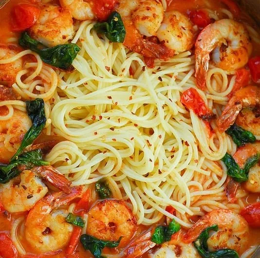 Shrimp pasta dish with garlic basil tomato sauce served in a bowl