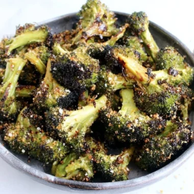 Delicious roasted broccoli with lemon and garlic garnished on a plate