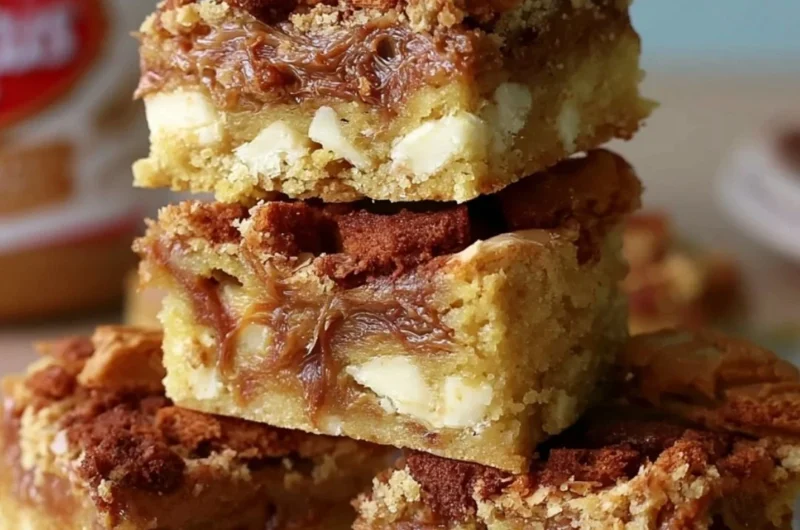 Biscoff Blondies topped with white chocolate chips and drizzled with sauce