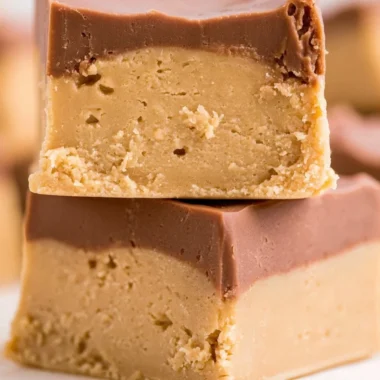 Delicious homemade Buckeye Fudge topped with chocolate and peanut butter.