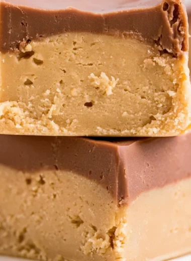 Delicious homemade Buckeye Fudge topped with chocolate and peanut butter.