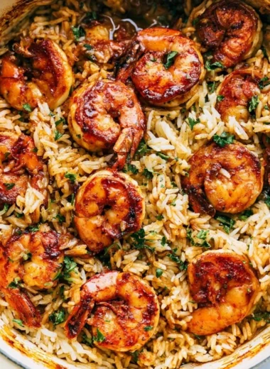 Cajun shrimp served over rice with vibrant veggies and spices.