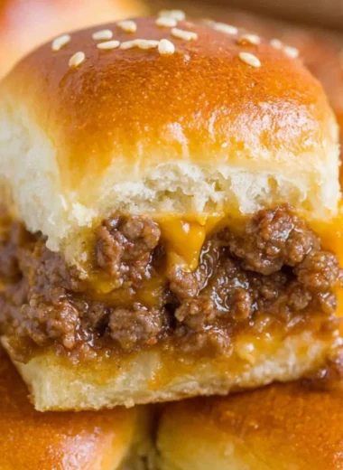 Plate of mouth-watering cheeseburger sliders garnished with fresh greens