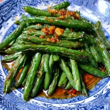 Stir fry of Chinese green beans with garlic and spices in a skillet