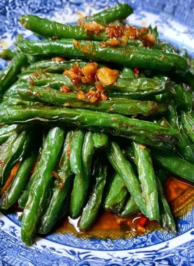 Stir fry of Chinese green beans with garlic and spices in a skillet