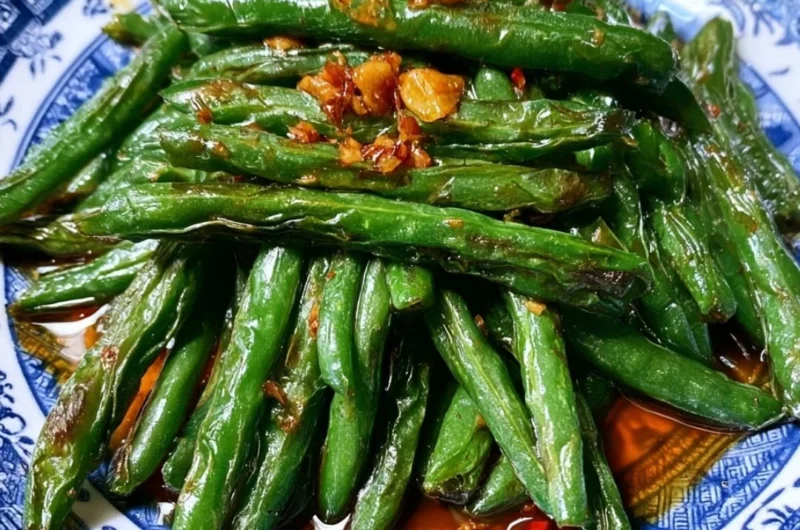 Stir fry of Chinese green beans with garlic and spices in a skillet