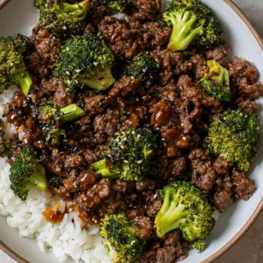 Cozy ground beef and broccoli dish served in a bowl with a side of rice