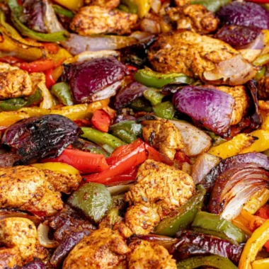 A delicious serving of cozy sheet pan chicken fajitas with colorful peppers.