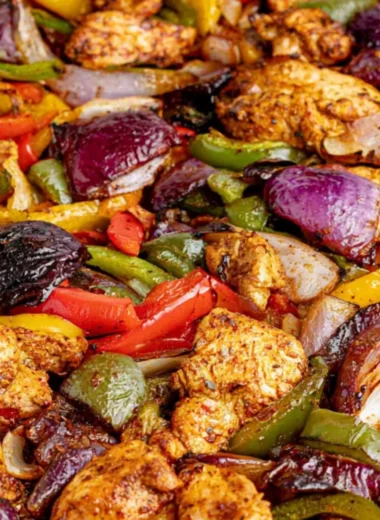 A delicious serving of cozy sheet pan chicken fajitas with colorful peppers.