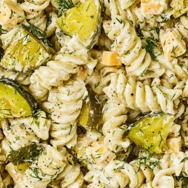 Bowl of Dill Pickle Pasta Salad with fresh ingredients and herbs