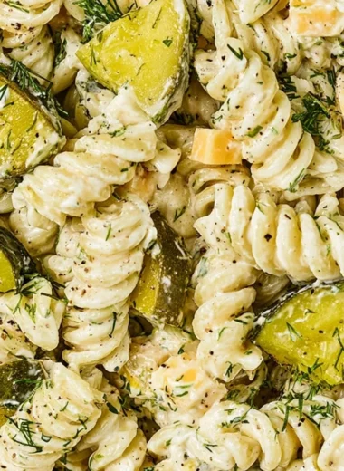 Bowl of Dill Pickle Pasta Salad with fresh ingredients and herbs