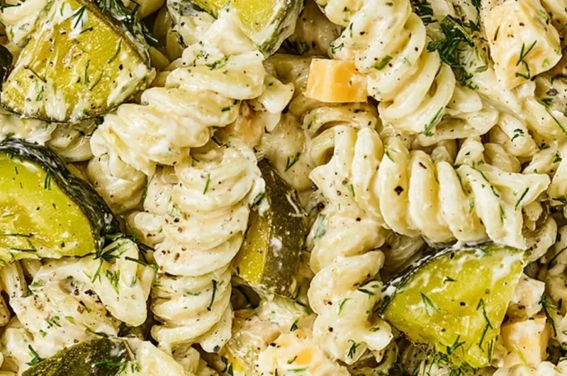 Bowl of Dill Pickle Pasta Salad with fresh ingredients and herbs