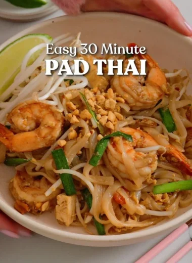 A plate of easy Thai street food featuring delicious noodles and fresh herbs.