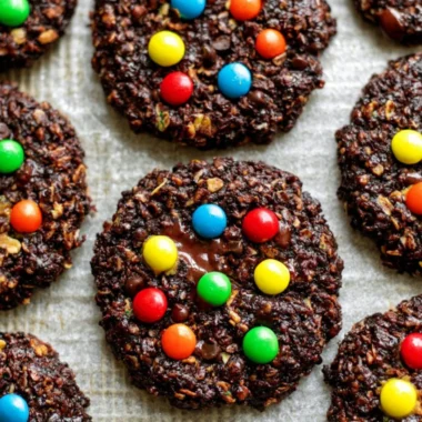 Healthy flourless chocolate monster cookies stacked on a plate