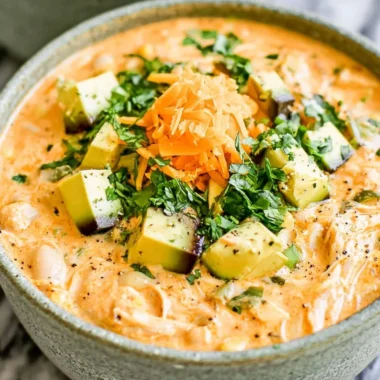 Healthy high protein white chicken chili served in a bowl with toppings