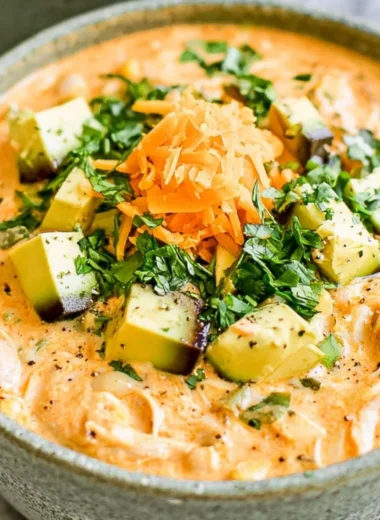 Healthy high protein white chicken chili served in a bowl with toppings