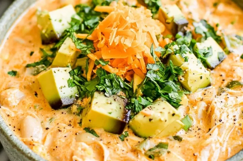 Healthy high protein white chicken chili served in a bowl with toppings