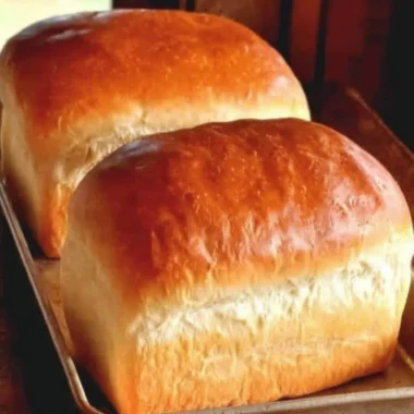 Freshly baked homemade Amish white bread on a wooden table