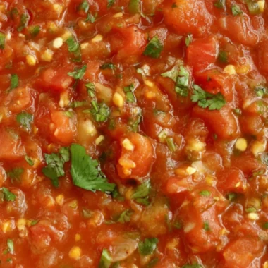 Bowl of homemade smoked salsa with fresh ingredients and tortilla chips