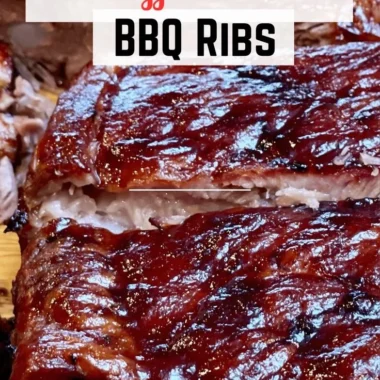 Delicious St. Louis ribs served with barbecue sauce and sides