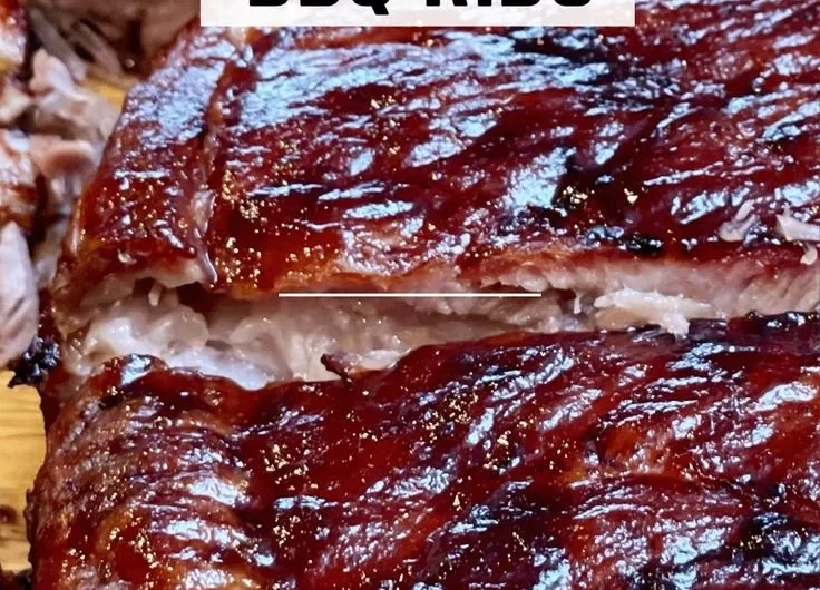 Delicious St. Louis ribs served with barbecue sauce and sides