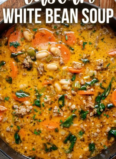 Bowl of homemade Tuscan white bean soup garnished with herbs.