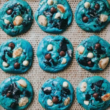 Delicious and colorful Cookie Monster cookies stacked on a plate