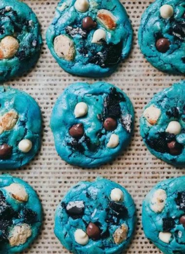 Delicious and colorful Cookie Monster cookies stacked on a plate