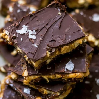 Viral chocolate date bark topped with nuts and drizzled with chocolate.