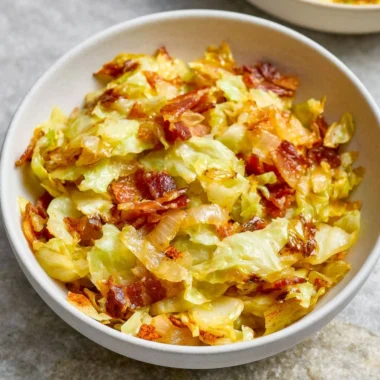 Delicious bacon and cabbage stir fry served in a bowl with colorful vegetables