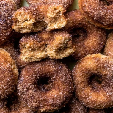 Delicious baked apple cider donuts on a plate, perfect for fall treats.