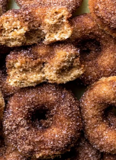 Delicious baked apple cider donuts on a plate, perfect for fall treats.