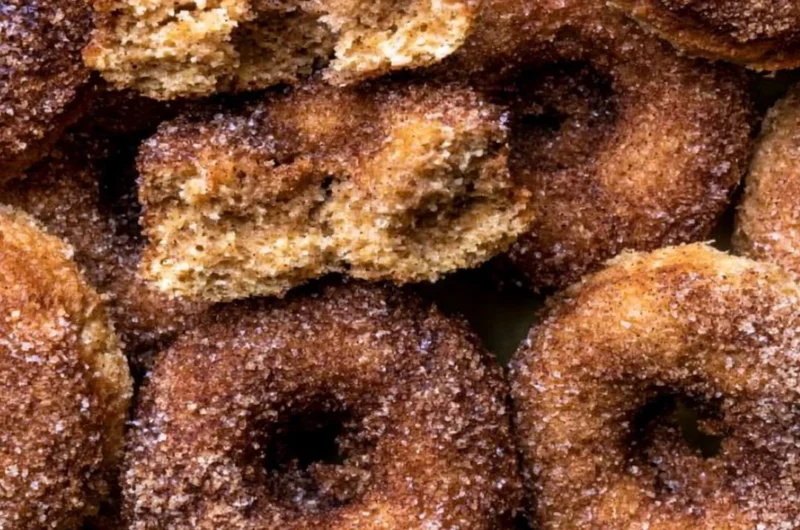 Delicious baked apple cider donuts on a plate, perfect for fall treats.