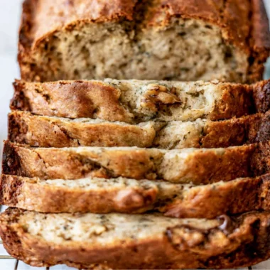 Sliced easy banana bread on a wooden cutting board