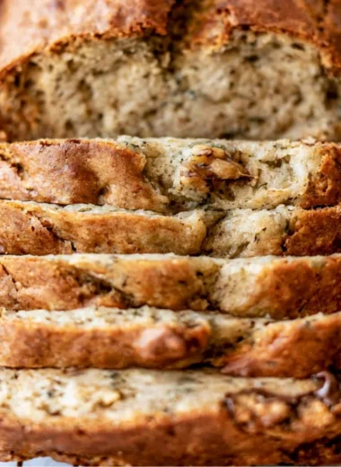 Sliced easy banana bread on a wooden cutting board
