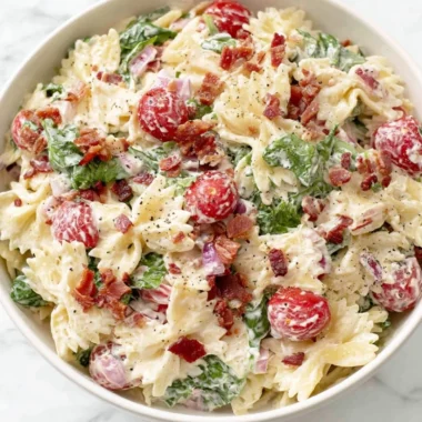 Delicious BLT Pasta Salad with bacon, lettuce, and tomatoes in a bowl.