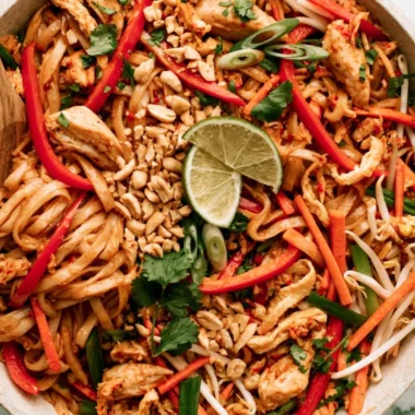 Delicious Chicken Pad Thai served with lime and peanuts