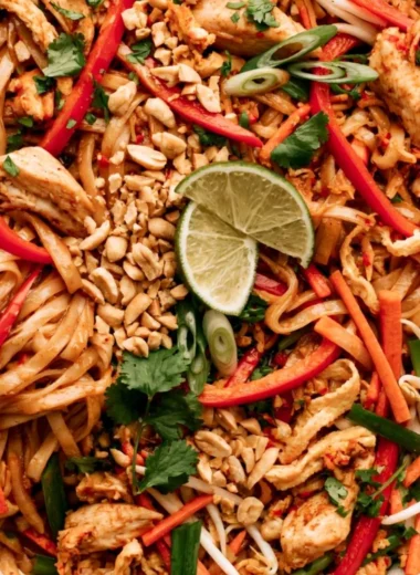 Delicious Chicken Pad Thai served with lime and peanuts