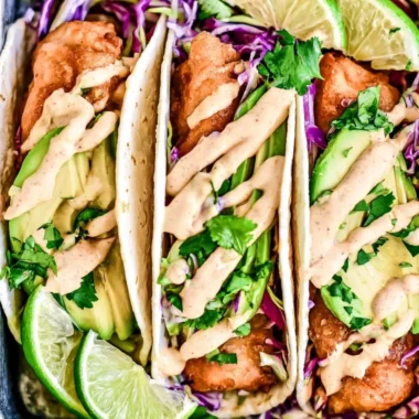 Deliciously prepared cozy Baja fish tacos topped with fresh ingredients.