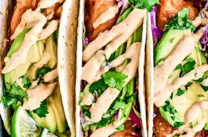 Deliciously prepared cozy Baja fish tacos topped with fresh ingredients.