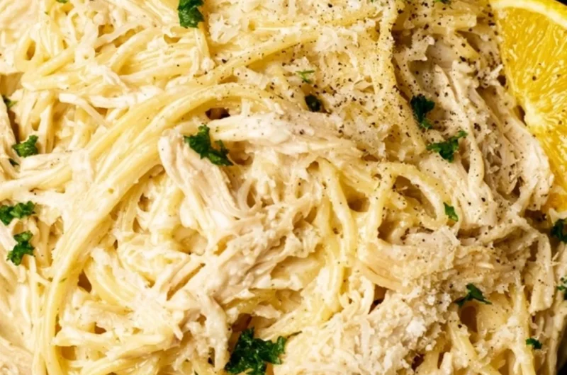 Creamy lemon chicken pasta served on a plate with fresh herbs and lemon slices