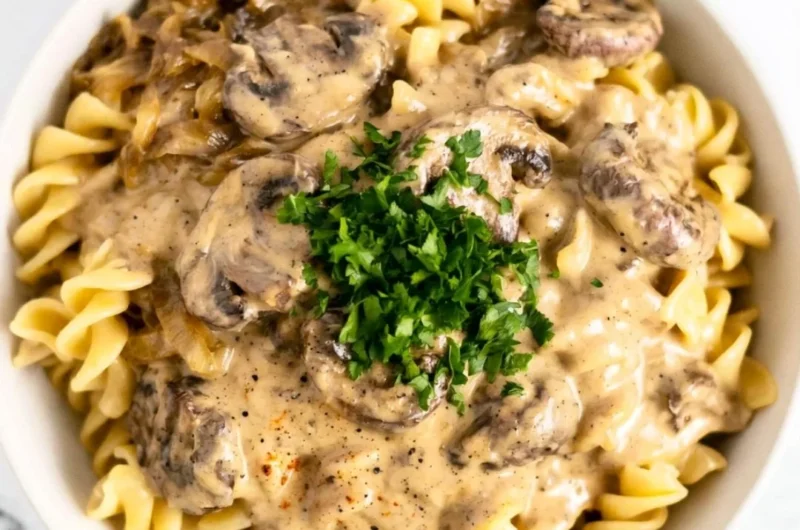 Creamy vegetarian mushroom stroganoff served in a bowl with herbs