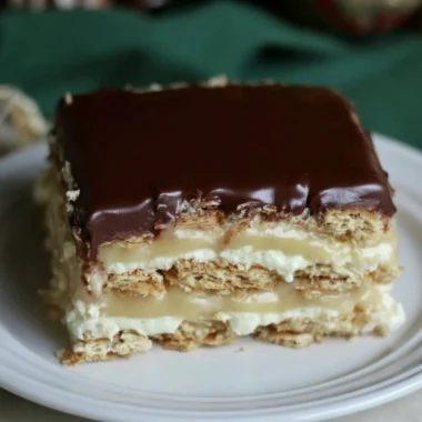 Delicious Eclair Icebox Cake layered with cream and chocolate.