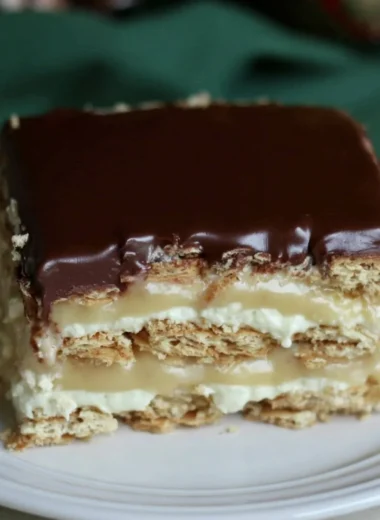 Delicious Eclair Icebox Cake layered with cream and chocolate.
