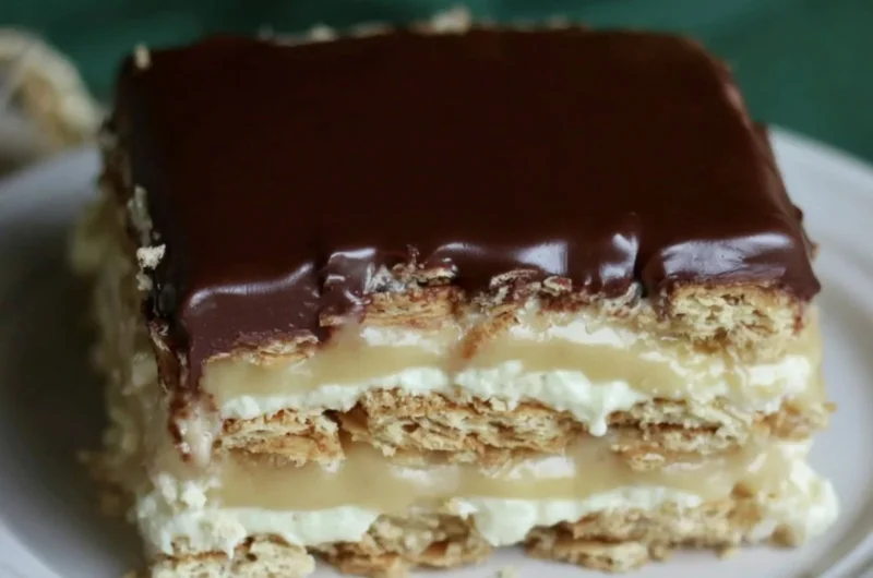 Delicious Eclair Icebox Cake layered with cream and chocolate.